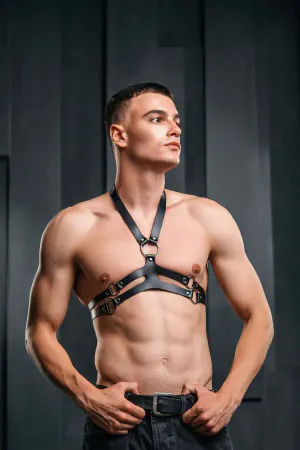 Black faux leather chest harness with O-ring detail and adjustable straps