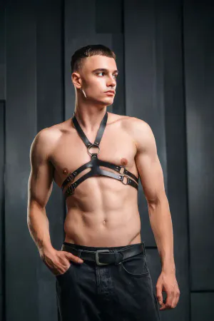 Black faux leather chest harness with O-ring detail and adjustable straps