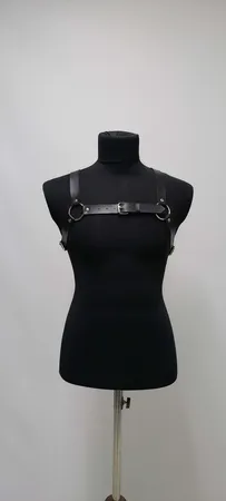 Black faux leather strappy chest harness with O-ring and buckle