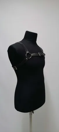 Black faux leather strappy chest harness with O-ring and buckle