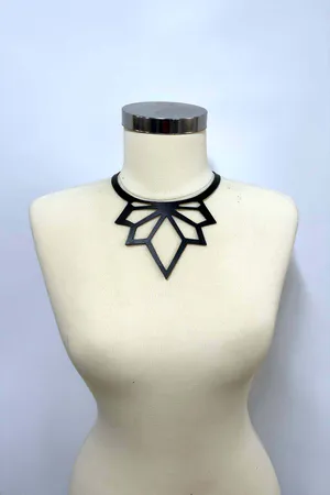 Black faux leather geometric laser cut choker necklace on mannequin neck