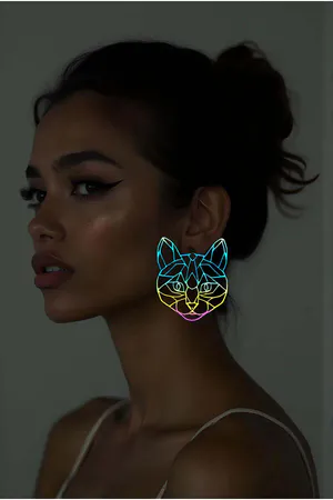 Reflective Geometric Cat Earrings rainbow iridescent effect worn by model in low light, glowing outline profile