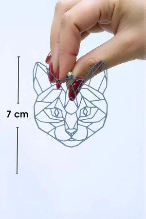 Reflective Geometric Cat Earrings rainbow iridescent effect worn by model in low light, glowing outline profile