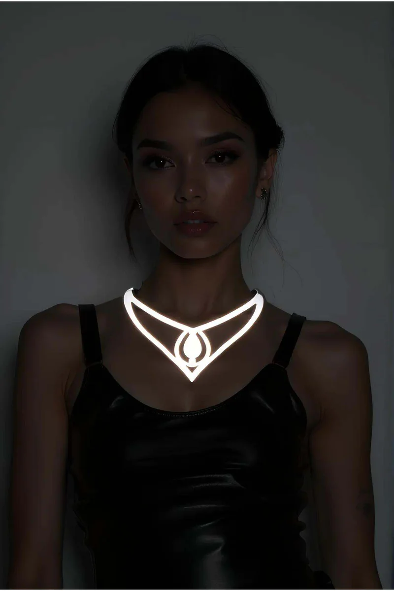 Reflective geometric choker necklace with central drop pendant on a model