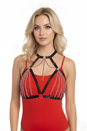 Black faux leather body harness with cascading silver chains and O-ring details worn by a model