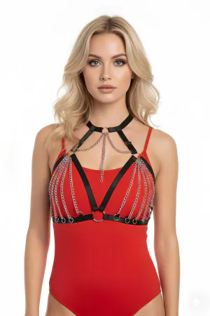 Black faux leather body harness with cascading silver chains and O-ring details worn by a model