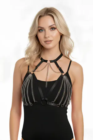 Black faux leather body harness with cascading silver chains and O-ring details worn by a model
