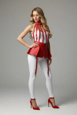 Red faux leather integrated harness top with flared mini skirt, model wearing black heels and white leggings.