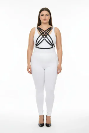 Black faux leather strappy chest harness worn by a plus-size model