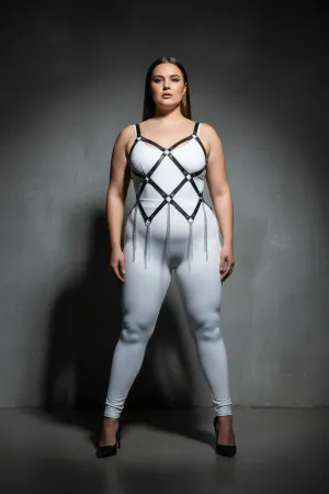 Black faux leather full body harness with diamond lattice and silver chain fringe, worn by a plus-size model
