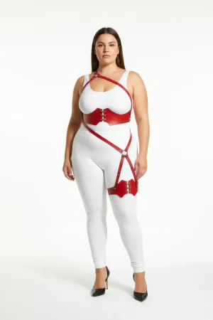 Red vegan leather strappy body harness with O-ring leg detail worn by a model
