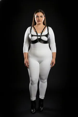 Black faux leather strappy harness bra with central O-ring detail worn by a plus-size model