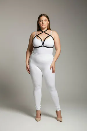 Black faux leather strappy chest harness with O-ring detail worn by a plus-size model