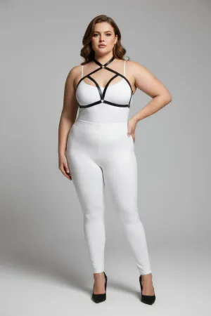 Black faux leather strappy chest harness with O-ring detail worn by a plus-size model