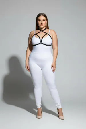 Black faux leather strappy chest harness with O-ring detail worn by a plus-size model
