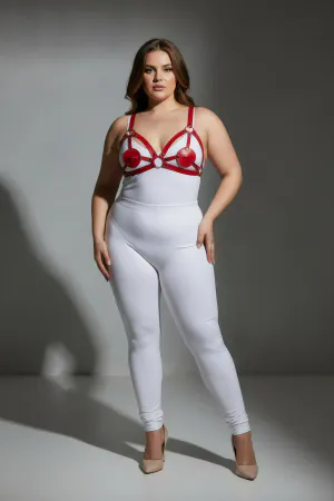 Red faux leather strappy harness with heart details and silver rings worn by a plus-size model