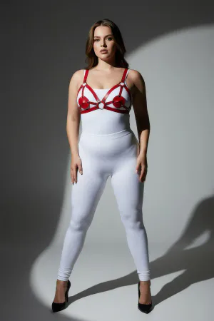 Red faux leather strappy harness with heart details and silver rings worn by a plus-size model