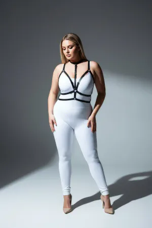 Black faux leather strappy body harness with central O-ring detail, worn by a plus-size model.