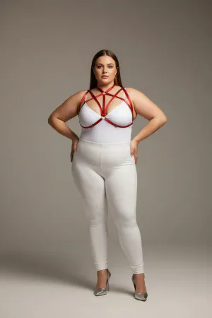 Red faux leather strappy chest harness with O-ring detail worn by a plus-size model
