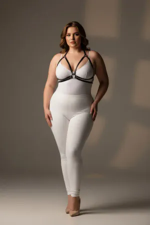 Black minimalist faux leather chest harness with central O-ring and adjustable straps worn by a plus-size model.