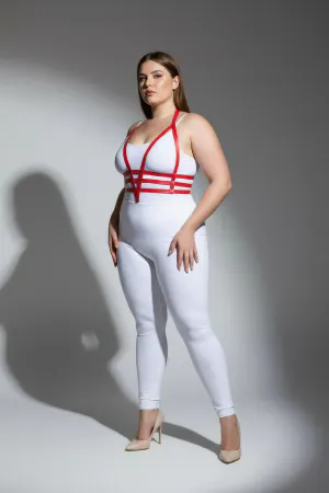 Red faux leather body harness with adjustable straps worn by a plus size model