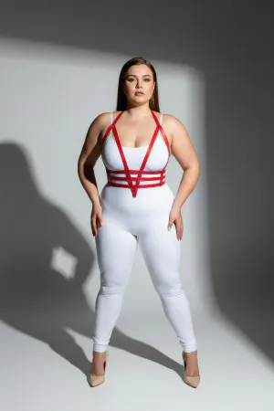 Red faux leather body harness with adjustable straps worn by a plus size model