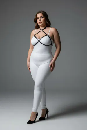 Black faux leather strappy chest harness with O-ring details, worn by a plus-size model.