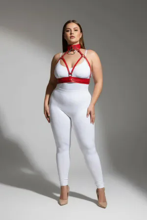 Red faux leather strappy body harness with matching choker and O-ring, worn by a plus-size model.