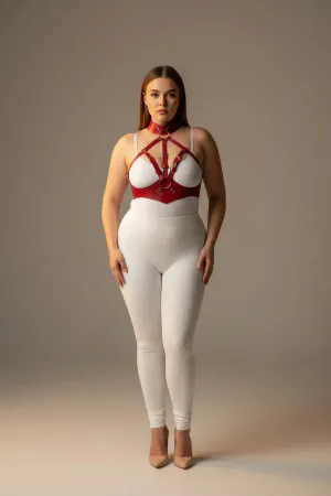 Red faux leather full body harness with integrated choker collar and silver O-ring, worn by a model.