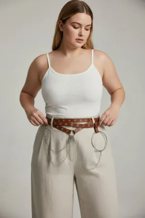 Brown Faux Leather Waist Harness with Draped Chains and O-Ring worn over a cream dress