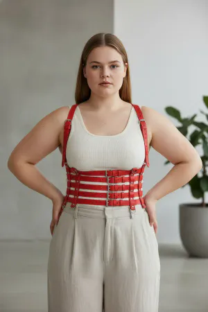 Red Faux Leather Multi-Strap Body Harness, worn over a white tank top with beige pants