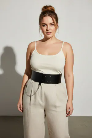 Black Faux Leather Wide Waist Belt with Silver Chain Detail, worn by a woman with a white top and light trousers